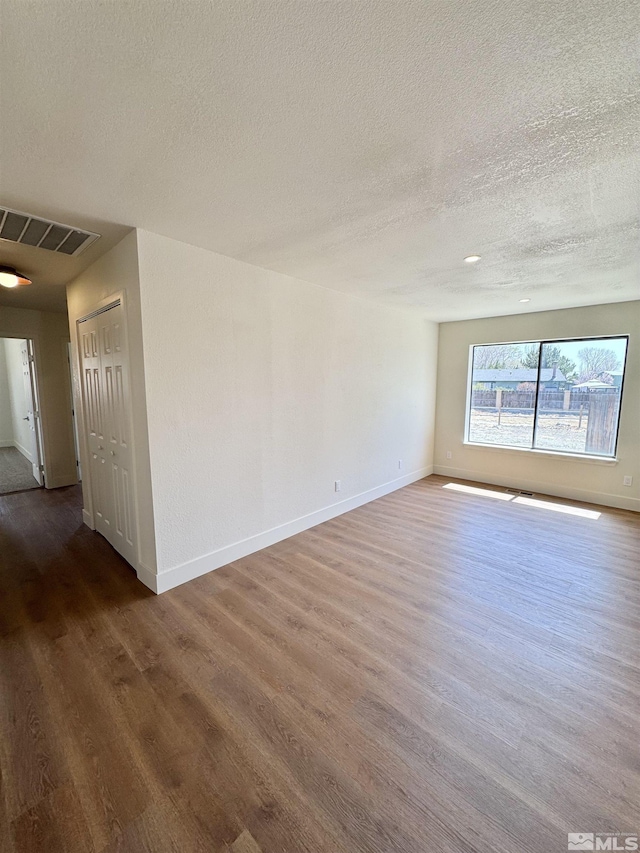3003 Alcorn Rd, Fallon, NV 89406 - empty room featuring a textured ceiling, wood finished floors, and baseboards