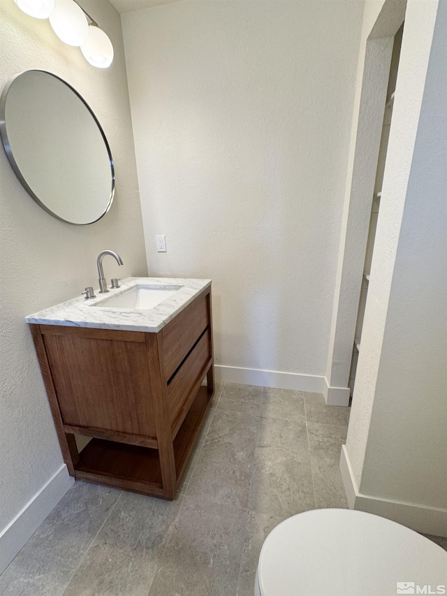 3003 Alcorn Rd, Fallon, NV 89406 - bathroom featuring vanity, toilet, and baseboards