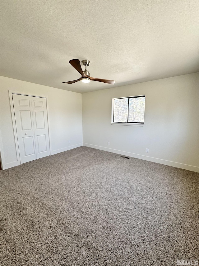 3003 Alcorn Rd, Fallon, NV 89406 - unfurnished bedroom with a textured ceiling, a closet, baseboards, carpet floors, and a ceiling fan