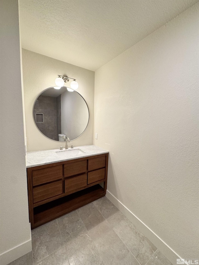 3003 Alcorn Rd, Fallon, NV 89406 - bathroom featuring vanity, baseboards, and a textured ceiling