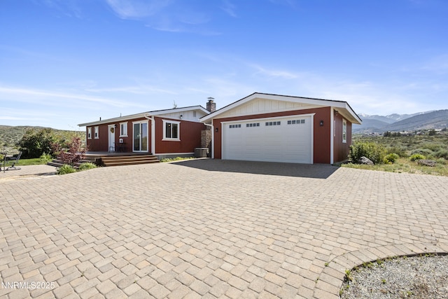 15900 Curtis Ln, Reno, NV 89511 - ranch-style home with decorative driveway, a mountain view, and a porch