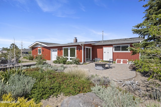 15900 Curtis Ln, Reno, NV 89511 - back of property with a patio, a fire pit, and a chimney