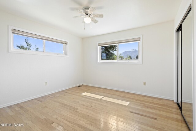 15900 Curtis Ln, Reno, NV 89511 - unfurnished bedroom with a closet, light wood-style flooring, baseboards, and a ceiling fan