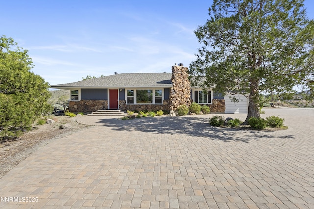15900 Curtis Ln, Reno, NV 89511 - view of front of property featuring decorative driveway, a chimney, stone siding, and an attached garage