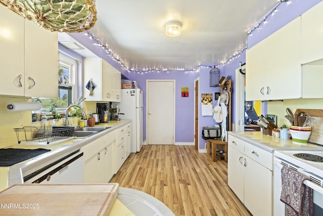 15900 Curtis Ln, Reno, NV 89511 - kitchen featuring white appliances, a sink, light countertops, light wood-style floors, and white cabinetry