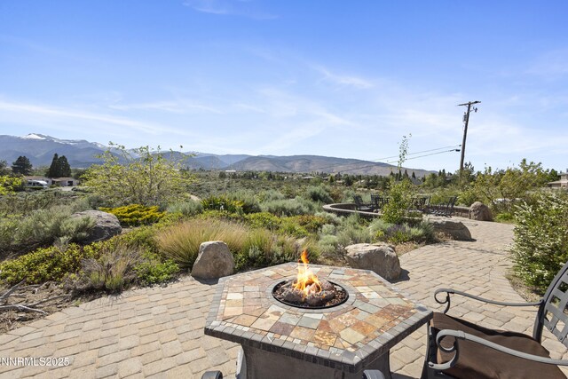 15900 Curtis Ln, Reno, NV 89511 - view of patio with an outdoor fire pit and a mountain view