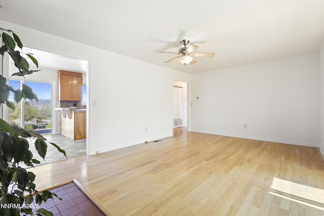 15900 Curtis Ln, Reno, NV 89511 - unfurnished living room with a ceiling fan, light wood-style flooring, and baseboards
