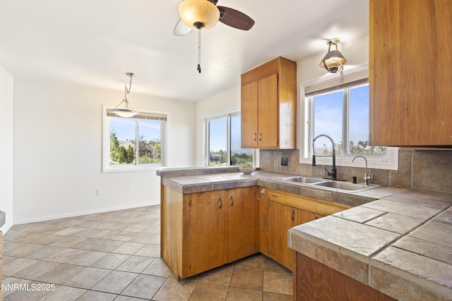15900 Curtis Ln, Reno, NV 89511 - kitchen with a sink, a peninsula, healthy amount of natural light, and decorative backsplash