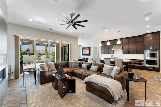6103 S Pleasant Oak Trl, Reno, NV 89511 - living area with a tile fireplace, recessed lighting, and a ceiling fan
