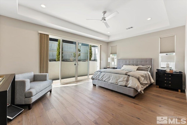 6103 S Pleasant Oak Trl, Reno, NV 89511 - bedroom featuring a raised ceiling, access to exterior, hardwood / wood-style floors, and recessed lighting