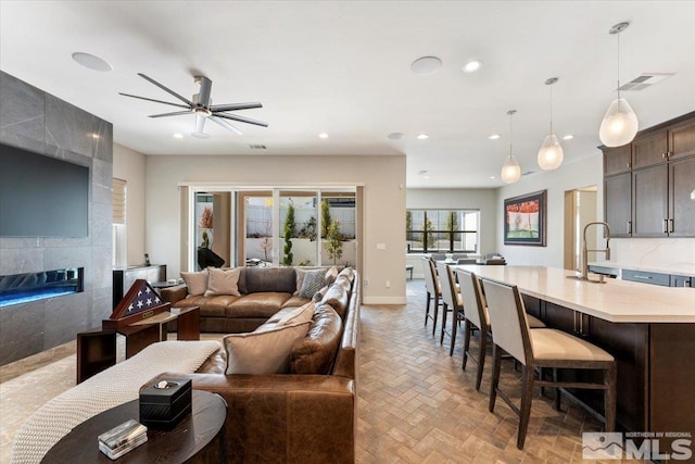 6103 S Pleasant Oak Trl, Reno, NV 89511 - living area with ceiling fan, baseboards, recessed lighting, and a tile fireplace