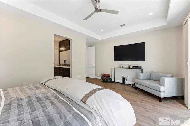 6103 S Pleasant Oak Trl, Reno, NV 89511 - bedroom with light wood finished floors, recessed lighting, a raised ceiling, connected bathroom, and ceiling fan