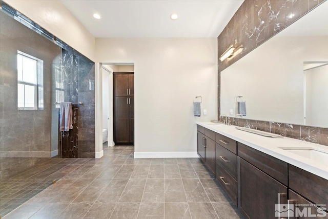 6103 S Pleasant Oak Trl, Reno, NV 89511 - bathroom with double vanity, toilet, recessed lighting, baseboards, and a shower