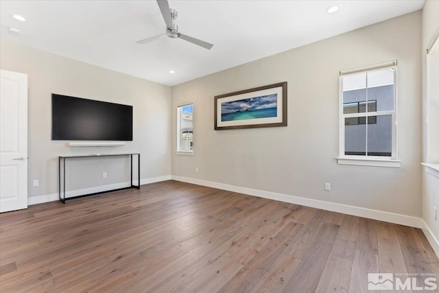 6103 S Pleasant Oak Trl, Reno, NV 89511 - unfurnished living room featuring wood finished floors, a ceiling fan, baseboards, and recessed lighting