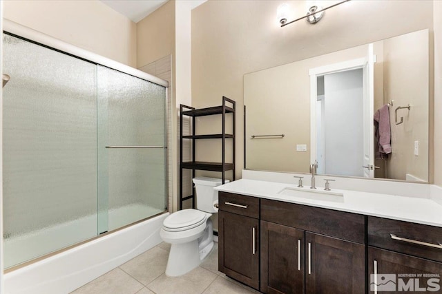 6103 S Pleasant Oak Trl, Reno, NV 89511 - full bathroom with toilet, tile patterned floors, vanity, and combined bath / shower with glass door