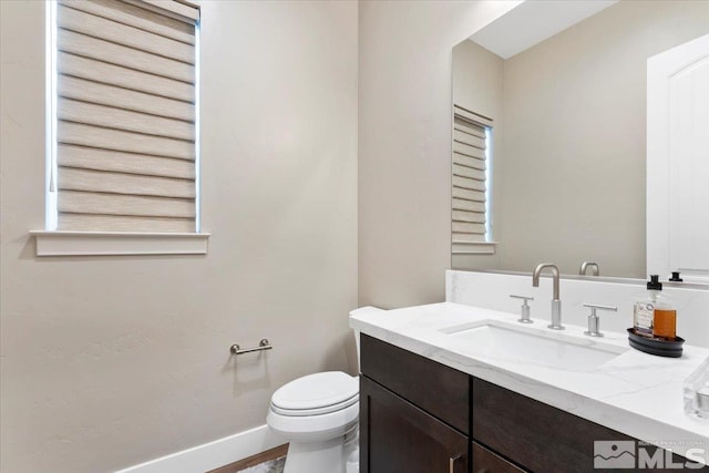 6103 S Pleasant Oak Trl, Reno, NV 89511 - half bathroom with toilet, vanity, and baseboards