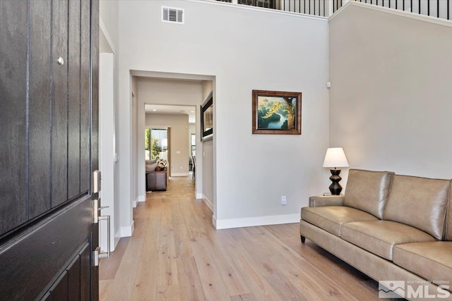 6103 S Pleasant Oak Trl, Reno, NV 89511 - foyer with light wood-style flooring, a towering ceiling, and baseboards