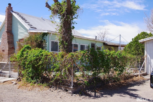 608 A St, Mina, NV 89422 - view of side of home featuring a chimney
