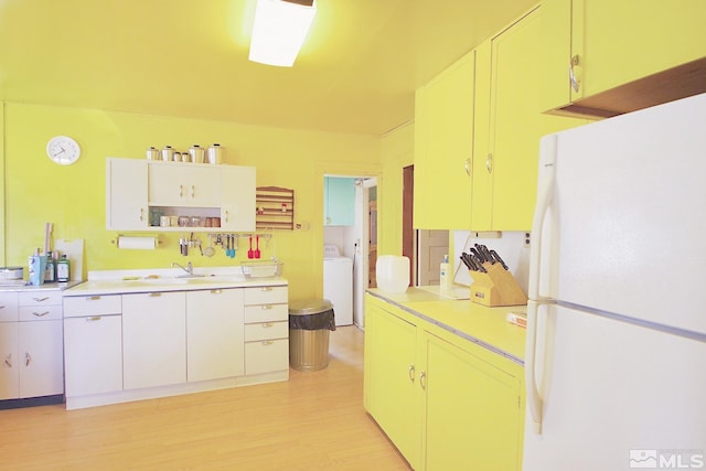 608 A St, Mina, NV 89422 - kitchen featuring freestanding refrigerator, washer / clothes dryer, light countertops, light wood finished floors, and open shelves