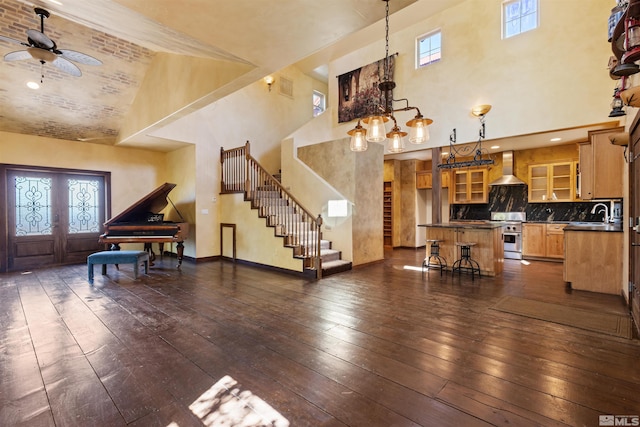 4775 Mount Rose Hwy, Reno, NV 89511 - living area with high vaulted ceiling, stairs, a ceiling fan, dark wood-style floors, and plenty of natural light