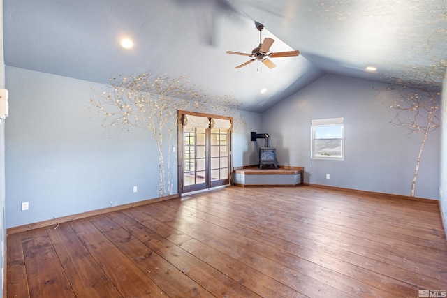 4775 Mount Rose Hwy, Reno, NV 89511 - unfurnished living room with a ceiling fan, vaulted ceiling, a wood stove, plenty of natural light, and wood-type flooring