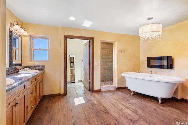 4775 Mount Rose Hwy, Reno, NV 89511 - bathroom featuring baseboards, hardwood / wood-style floors, a shower stall, double vanity, and a soaking tub