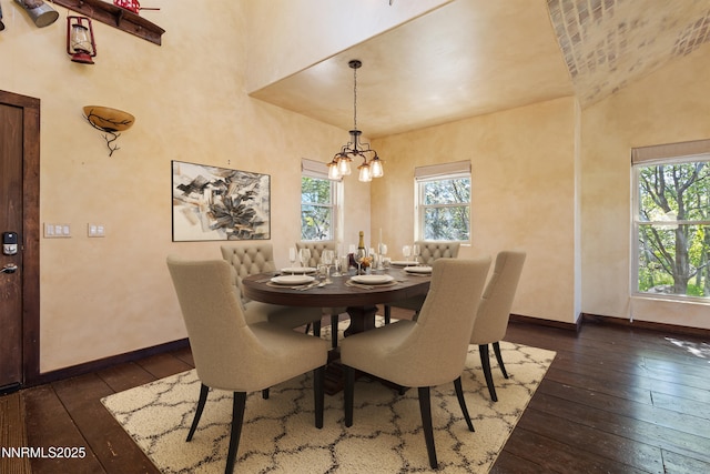 4775 Mount Rose Hwy, Reno, NV 89511 - dining room featuring dark wood finished floors, plenty of natural light, a chandelier, baseboards, and a towering ceiling
