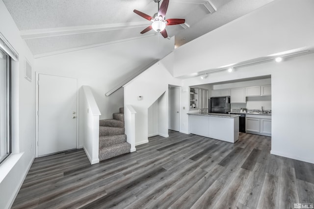 1465 E Peckham Ln Apt 20, Reno, NV 89502 - unfurnished living room featuring dark wood-style flooring, a ceiling fan, a textured ceiling, stairway, and baseboards