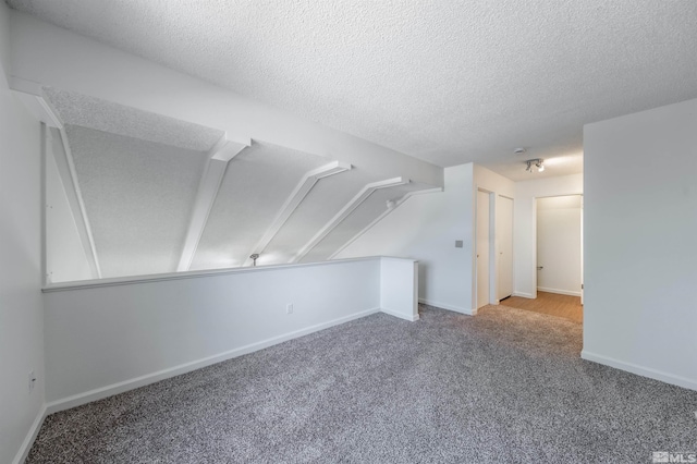 1465 E Peckham Ln Apt 20, Reno, NV 89502 - bonus room with carpet flooring, a textured ceiling, and baseboards