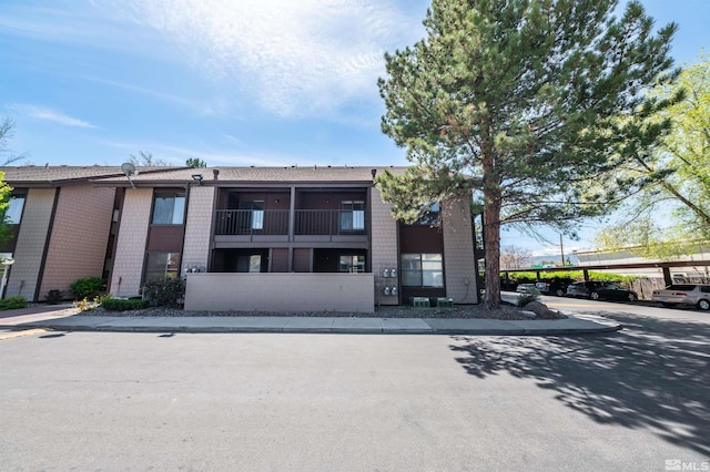1465 E Peckham Ln Apt 20, Reno, NV 89502 - view of property featuring covered parking
