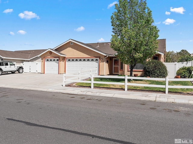 1343 White Bluffs Cir, Fernley, NV 89408 - view of front of house featuring a fenced front yard, an attached garage, stucco siding, driveway, and roof with shingles
