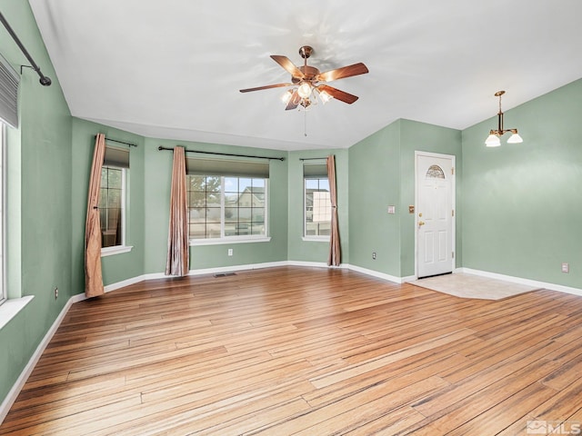 1343 White Bluffs Cir, Fernley, NV 89408 - unfurnished living room with light wood-style floors, a ceiling fan, and baseboards