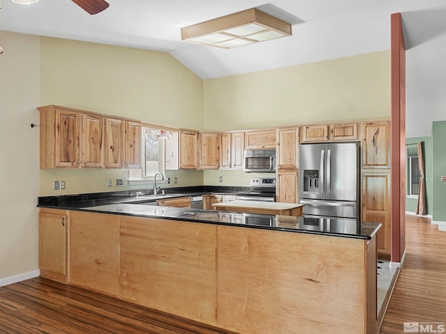 1343 White Bluffs Cir, Fernley, NV 89408 - kitchen featuring appliances with stainless steel finishes, high vaulted ceiling, a peninsula, light brown cabinetry, and dark wood finished floors