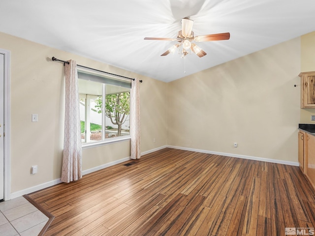 1343 White Bluffs Cir, Fernley, NV 89408 - unfurnished living room with wood finished floors, ceiling fan, and baseboards