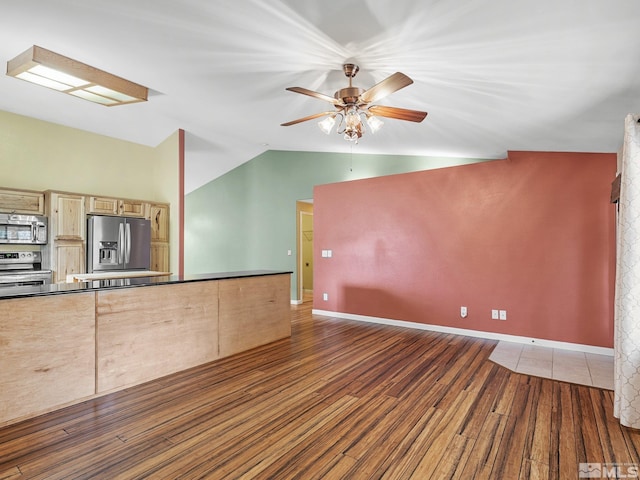 1343 White Bluffs Cir, Fernley, NV 89408 - unfurnished living room featuring wood finished floors, lofted ceiling, ceiling fan, and baseboards