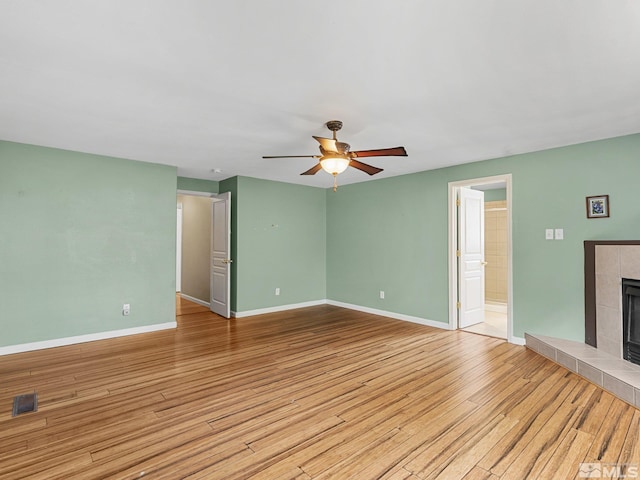 1343 White Bluffs Cir, Fernley, NV 89408 - unfurnished living room featuring ceiling fan, baseboards, light wood finished floors, and a fireplace