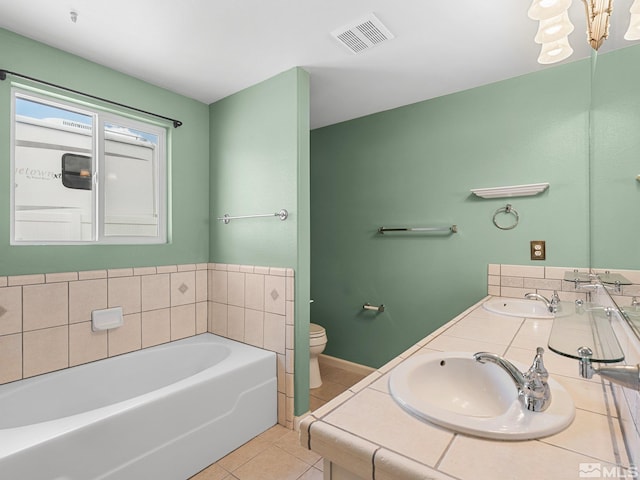 1343 White Bluffs Cir, Fernley, NV 89408 - bathroom featuring tile patterned flooring, toilet, a garden tub, double vanity, and a chandelier