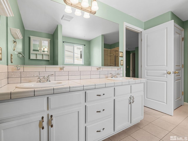 1343 White Bluffs Cir, Fernley, NV 89408 - full bath featuring tile patterned flooring, tiled shower, double vanity, and backsplash