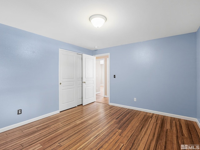 1343 White Bluffs Cir, Fernley, NV 89408 - unfurnished bedroom featuring baseboards, wood finished floors, and a closet