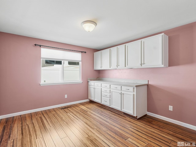 1343 White Bluffs Cir, Fernley, NV 89408 - kitchen with white cabinetry, baseboards, and light wood-type flooring