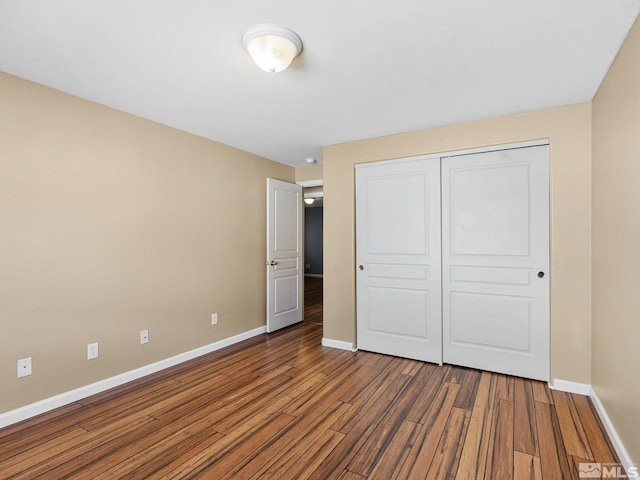 1343 White Bluffs Cir, Fernley, NV 89408 - unfurnished bedroom featuring baseboards, wood finished floors, and a closet