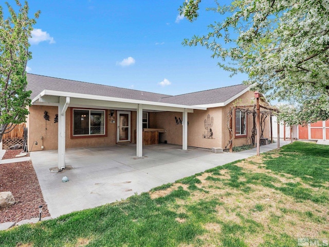 1343 White Bluffs Cir, Fernley, NV 89408 - rear view of house with stucco siding, a patio area, and a shingled roof