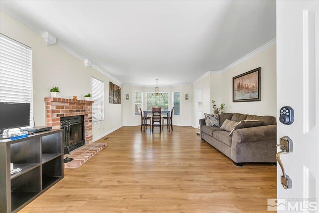 1280 O Callaghan Dr, Sparks, NV 89434 - living room featuring light wood finished floors, crown molding, a fireplace, and baseboards