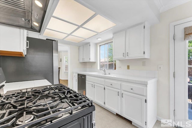 1280 O Callaghan Dr, Sparks, NV 89434 - kitchen with tile counters, appliances with stainless steel finishes, white cabinetry, and plenty of natural light