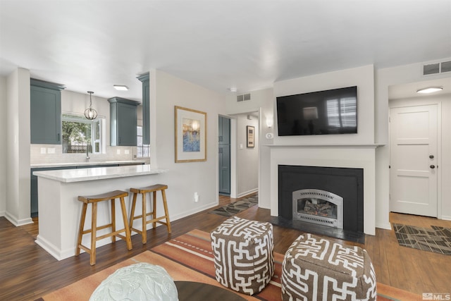 823 Arbutus St, Reno, NV 89509 - living area with dark wood-style floors, a fireplace with flush hearth, and baseboards