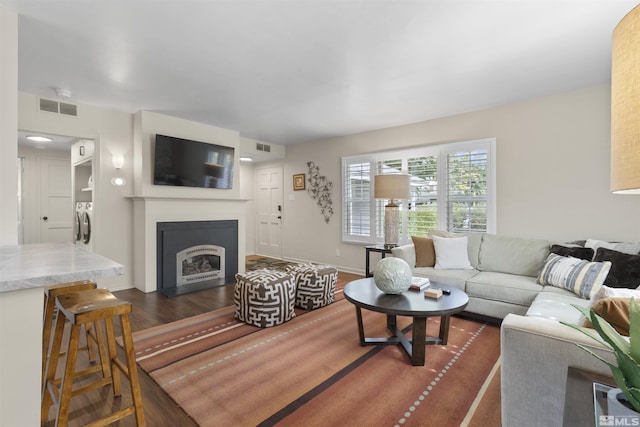 823 Arbutus St, Reno, NV 89509 - living area with a fireplace with flush hearth, dark wood-style flooring, and baseboards