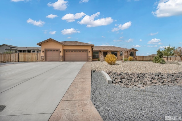 16885 Majestic View Dr, Reno, NV 89521 - view of front of property with a garage, fence, stone siding, and concrete driveway