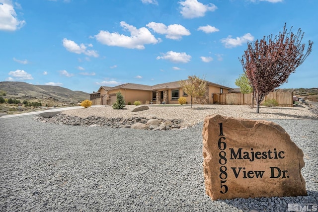 16885 Majestic View Dr, Reno, NV 89521 - view of front of property with fence, stucco siding, and a mountain view
