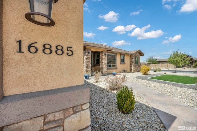 16885 Majestic View Dr, Reno, NV 89521 - exterior space featuring stone siding, stucco siding, and fence