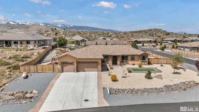 16885 Majestic View Dr, Reno, NV 89521 - view of front of house with a garage, covered porch, fence, driveway, and a mountain view